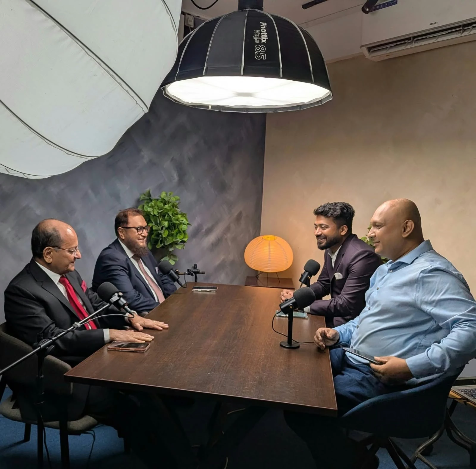 Professional roundtable conversation in a recording studio
